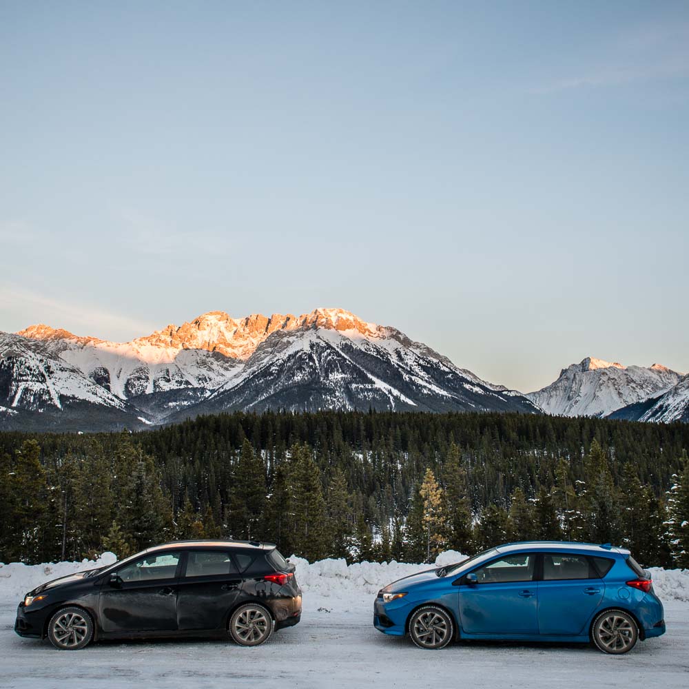 Two Scion iM cars sit in front of a canadian Rockies landscape in Kananaskis Country.